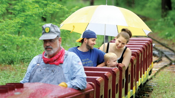 RAINY TRAIN. Some light rainfall couldn’t stop Andrew and Amanda Schrader and their son, Everett, from the diesel-powered mini-train in Carson Park on a recent Sunday.