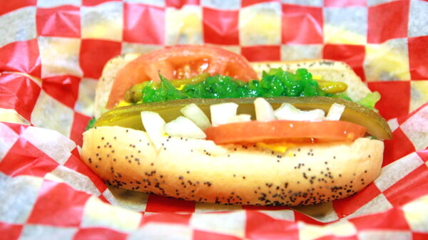 LET’S BE FRANK. Milwaukee import Dogg Haus offers Chicago-style hot dogs, like this one traditionally dressed with yellow mustard, onions, relish, tomatoes, peppers, a kosher pickle spear, topped with a dash of celery salt.
