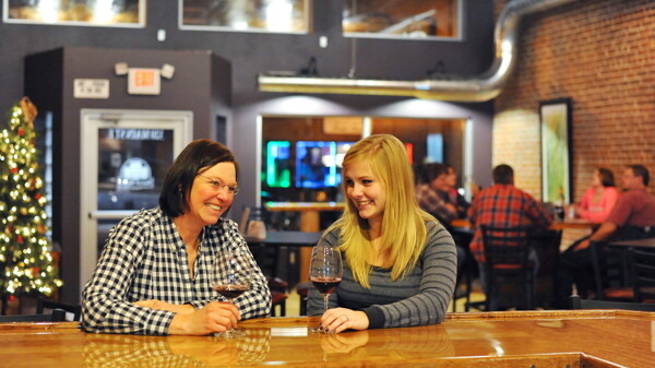 Quit WHINING AND START WINING. The Barrel Room, a wine bar on Main Street in Menomonie, offers more than 60 kinds of wine from around the world.