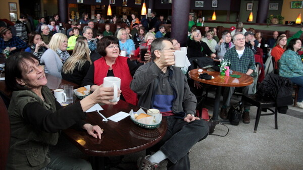A COZY TOAST. For 20 years, Eau Claire’s Acoustic Cafe has offered a relaxed, convivial atmosphere (as shown above during the annual St. Patrick’s Day celebration) as well as memorable hoagies and other edibles (left).