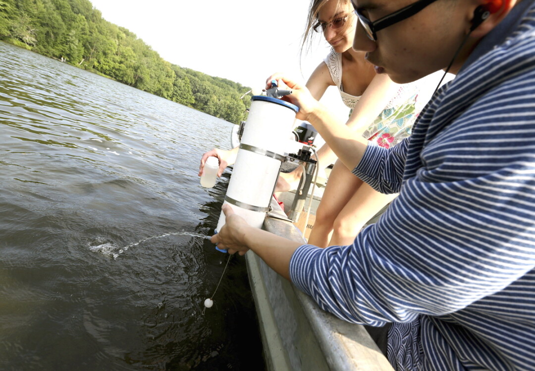 Students take a water sample from  Lake Menomin during the 2014 program.