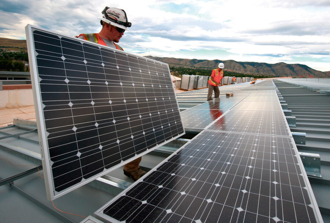 Workers install  solar  panels as part of a U.S. Department of Energy/Xcel project  in Colorado