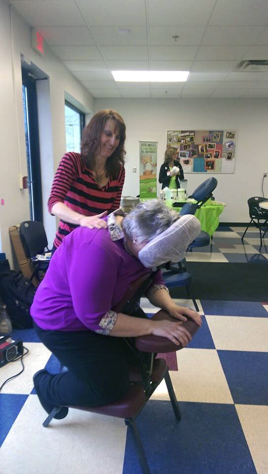 PUT YOUR BACK INTO IT. An employee gets a chair massage during a wellness event at eBay Enterprise.