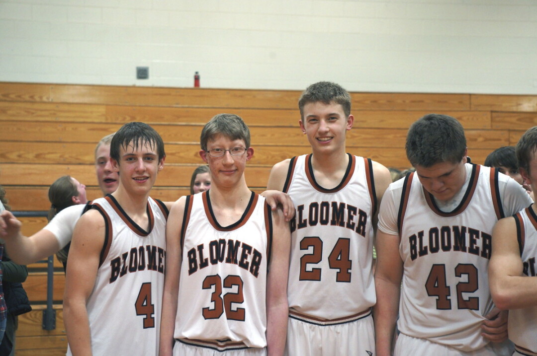 Zach Peterson (center) is flanked by teammates after scoring a three-pointer at the end of his first – and last – on-court appearance for the Bloomer Blackhawks. Zach was the team’s manager for four years.