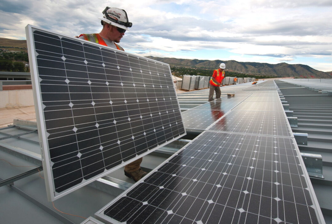 Workers install solar panels as part of an Xcel Energy project in Colorado. Image: U.S. Department of Energy