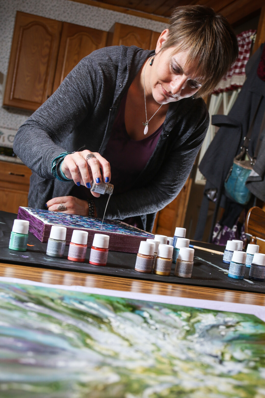 LET THE SPIRIT MOVE YOU. Artist Tanya Meyer creates one-of-a-kind art by pouring paint.