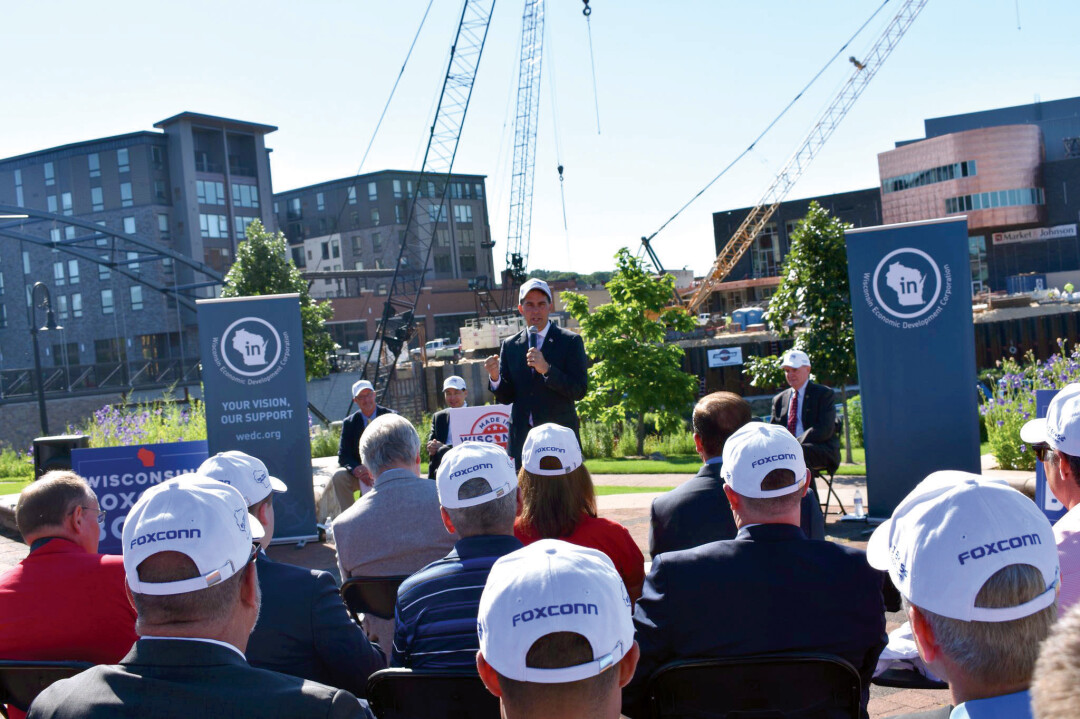 HUB HUBBUB. Gov. Scott Walker, center, speaks at Phoenix Park July 16 at an event annoucing Foxconn Technology Group’s plans to create a “technology hub” in Eau Claire, part of which will be inside the Haymarket Landing building, which is at the left side of the photo behind Walker.