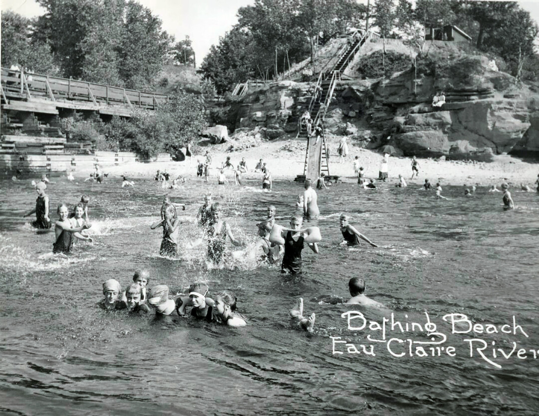 TAKE ME TO THE RIVER. Children and adults cool off in the Eau Claire River next to Boyd Park in this photo from the Chippewa Valley Museum’s collection, which was taken sometime between 1912 and 1932.