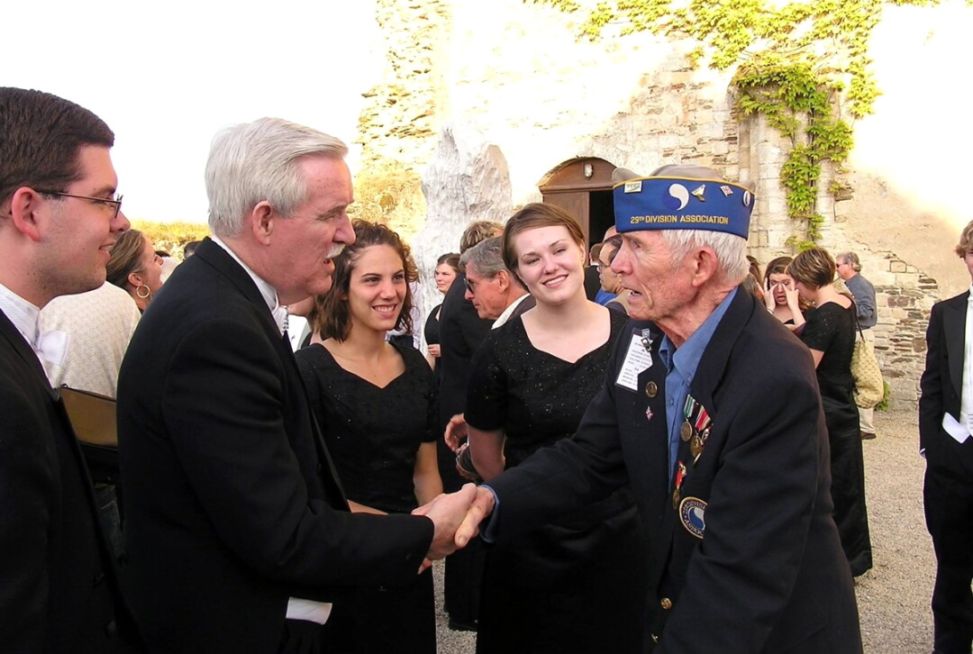 Dr. Gary Schwartzhoff, second from left, meets a veteran on the 60th anniversary of D-Day in France. He will lead the UW-Eau Claire Alumni Choir when it performs this summer at the 75th anniversary of D-Day.