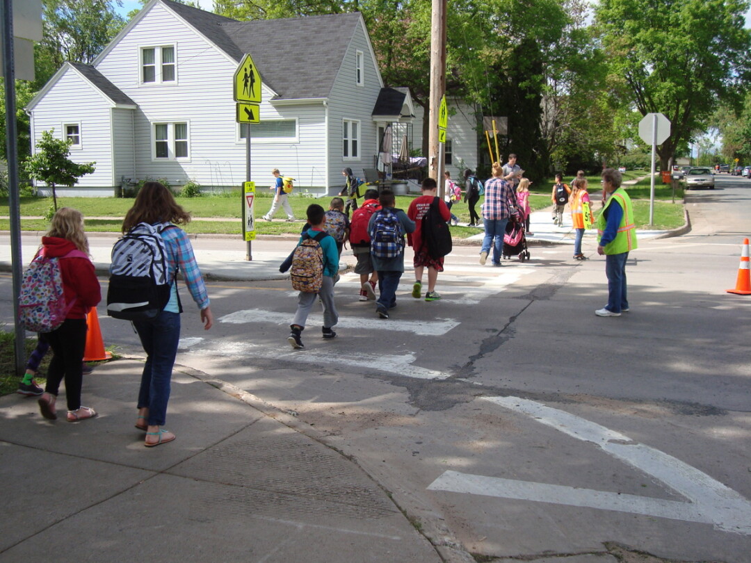 STROLLING SAFELY. Children cross Birch Street on their way to Longfellow School. The school year begins Sept. 3 in the Eau Claire school district.