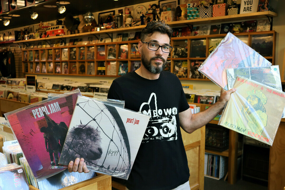 VINTAGE VINYL. Billy Siegel, proprietor of Revival Records in Eau Claire, with some of his most unique discs.