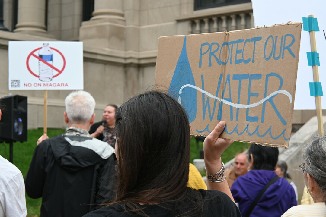 NOT KEEPING THEIR OPPOSITION BOTTLED UP. Critics of a proposed development agreement with Niagara Bottling rallied outside Eau Claire City Hall on Monday, June 13.