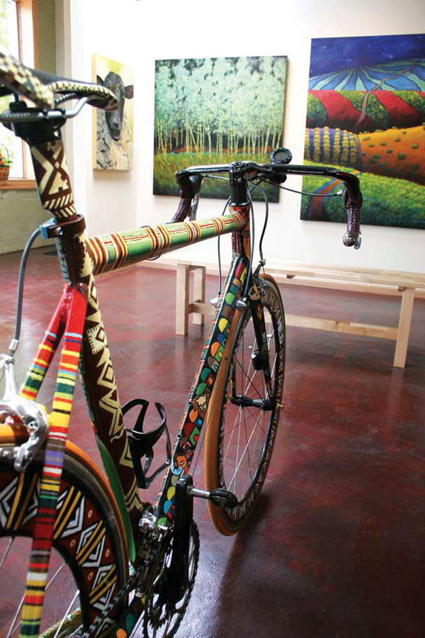 Gregg Rochester’s show, Le Tour d’Art, offers bicycles painted with unique patterns and imagery paired with abstract, colorful landscapes.