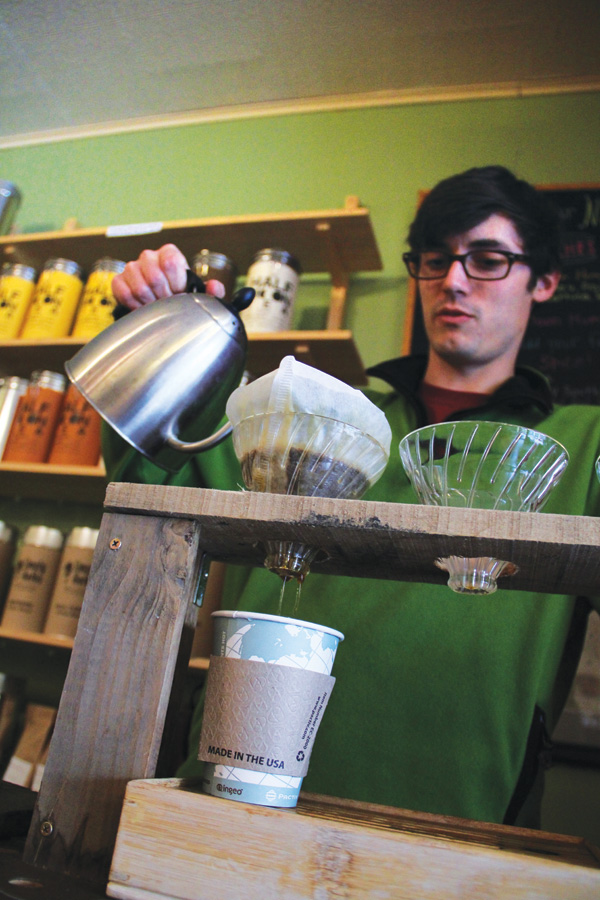 Half Moon Tea & Spice manager Colin Carey pours a cup of Kickapoo coffee, measured precisely for optimum taste.