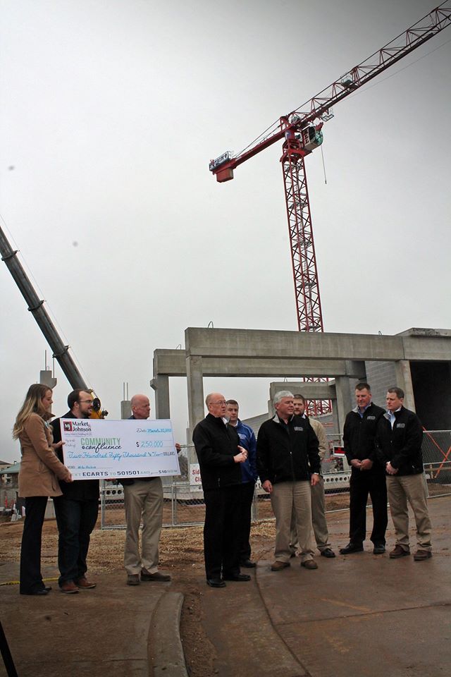 A big check from Market & Johnson –  at the Haymarket Landing sit on March 30. Image: Community for the Confluence