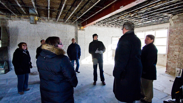 Members of the Wisconsin Economic Development Corp. tour the renovations in progress at the former Green Tree Inn in downtown Eau Claire.