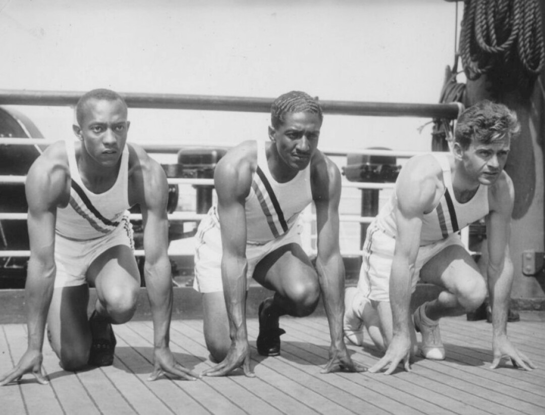 Metcalfe (center) with Jesse Owens and Frank Wykoff on the deck of the S. S. Manhattan as the team sailed for Germany in 1936. Image: Wikimedia Commons