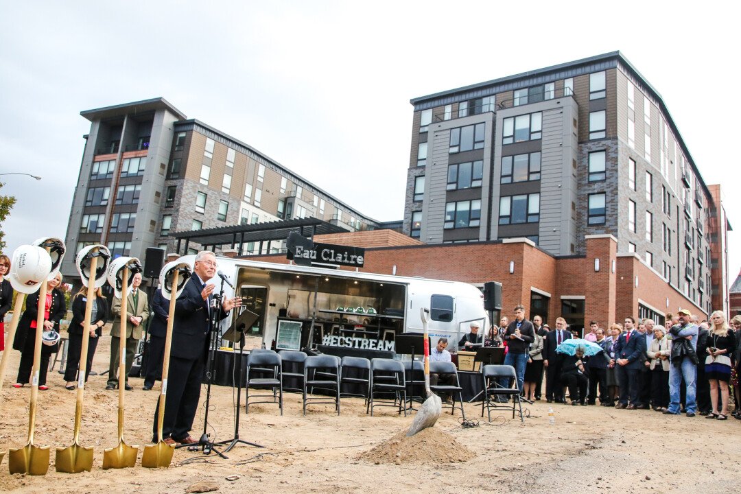 The Haymarket Plaza building watches over the groundbreaking, eagerly awaiting its mate. 