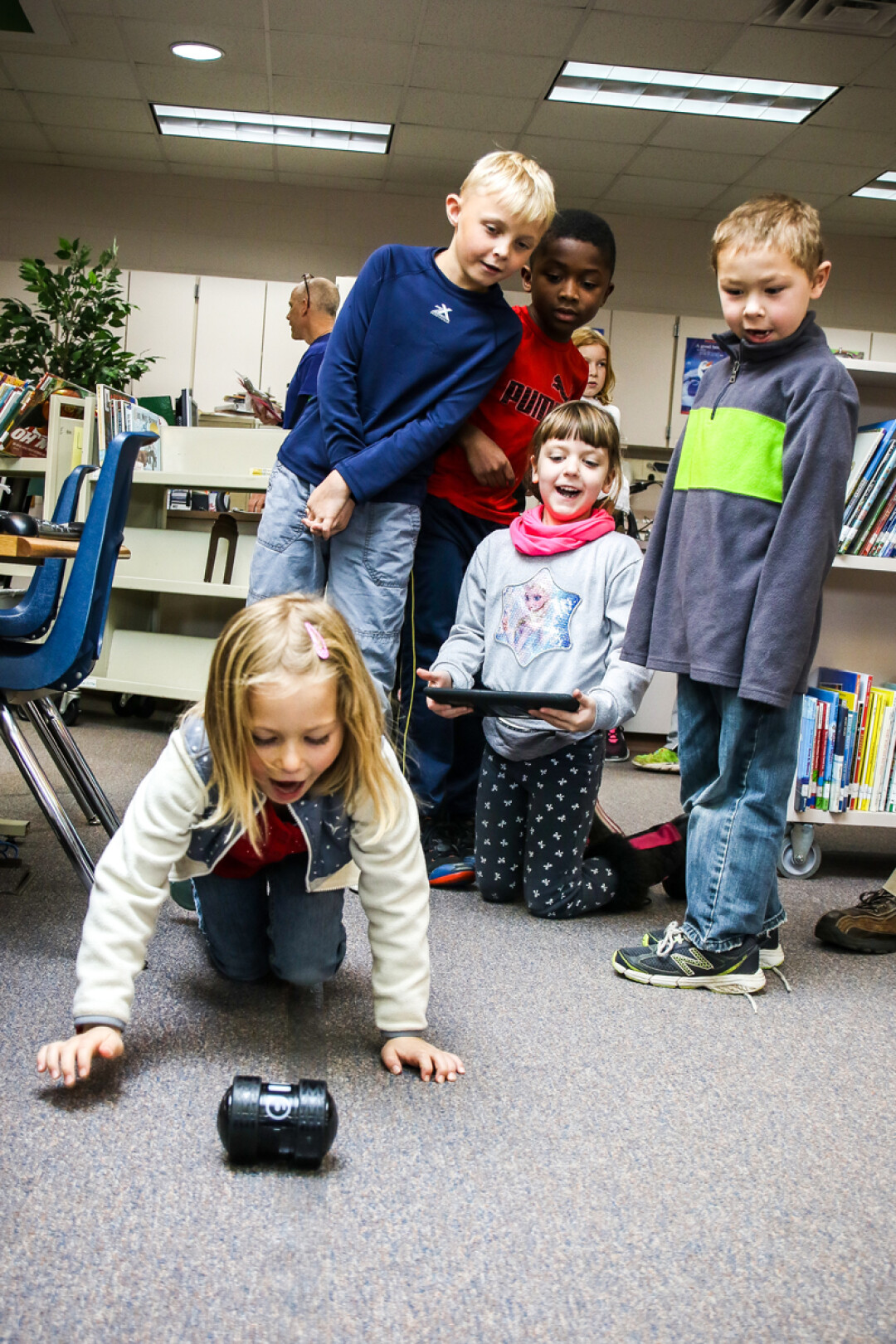 Chippewa Valley Montessori Charter School students – (from left to right) Rose, Bode, Saige, Esper, and Jack – programmed an Ollie robot to follow a predetermined route on the school library’s floor.