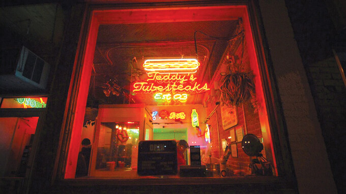 The glow of electric steaks in the window ...