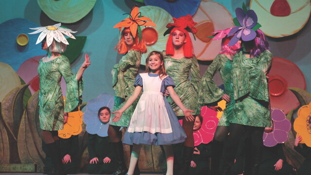 EVERYTHING’S COMING UP PSYCHEDELIC ROSES! Eau Claire Children’s Theatre put on 16 shows this season, many with child actors. Above: a recent production of Alice in Wonderland.