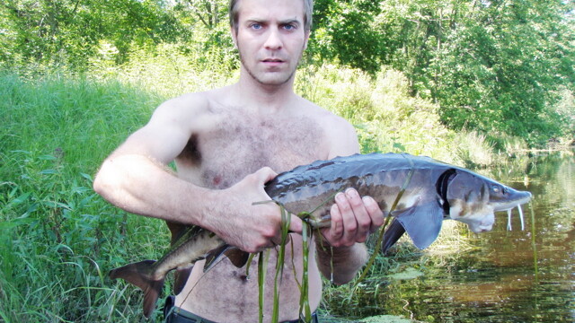 THE FACE OF WISCONSIN FISHING. ALSO, THE CHEST OF WISCONSIN FISHING. A cast member from Unprofessional Fisherman grasps the fruit of his latest aquatic hunting adventure.