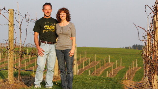 A LOT ON THE VINE. Co-owners Bob and Connie Dubiel pause amongst the vines of Sandstone Ridge Winery.