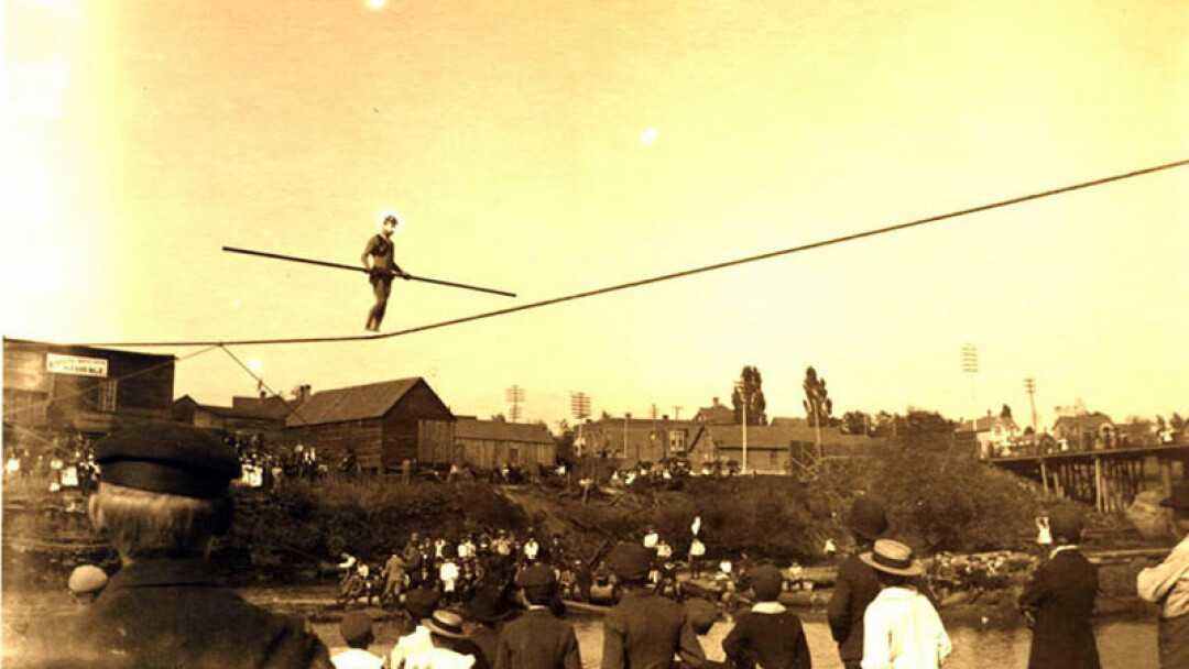 IT'S BEEN DONE! Old-timey river fun – a tight rope walker over the Eau Claire River near downtown EC..