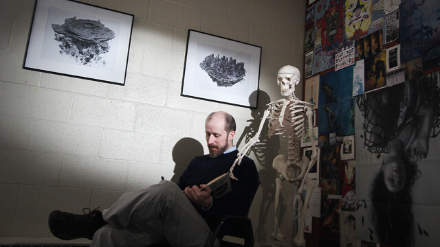 DEAD MAN DRAWING. Illustrator Ned Gannon sketches in his office at UW-Eau Claire with the company of his life drawing teaching aid.