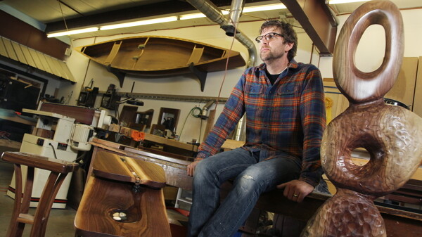 Tim Brudnicki, shown in his Eau Claire studio, incorporates local wood and stone into his furniture.