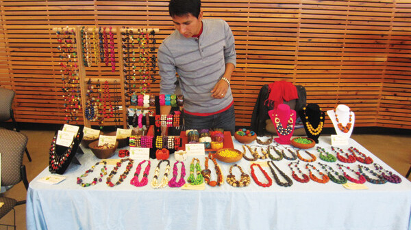 STICK YOUR NECK OUT. Juan Carlos displays his handmade jewelry, made with natural materials from Ecuador.