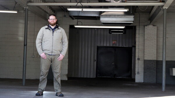 Will Glass, stands in its big, empty, temporary space in Eau Claire’s West Bank.