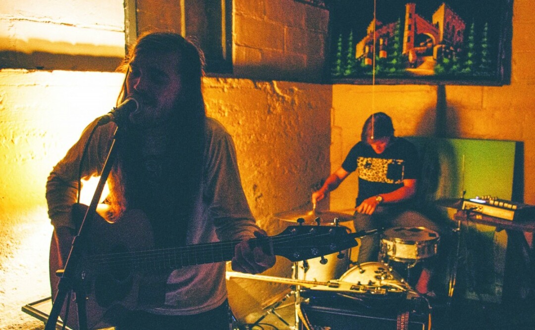 DOWN BELOW. Gabe Larson performs at the “Lake House” basement venue in Eau Claire. Larson, formerly of Reverii, has named his latest project – Waldemar – after his late grandfather. 