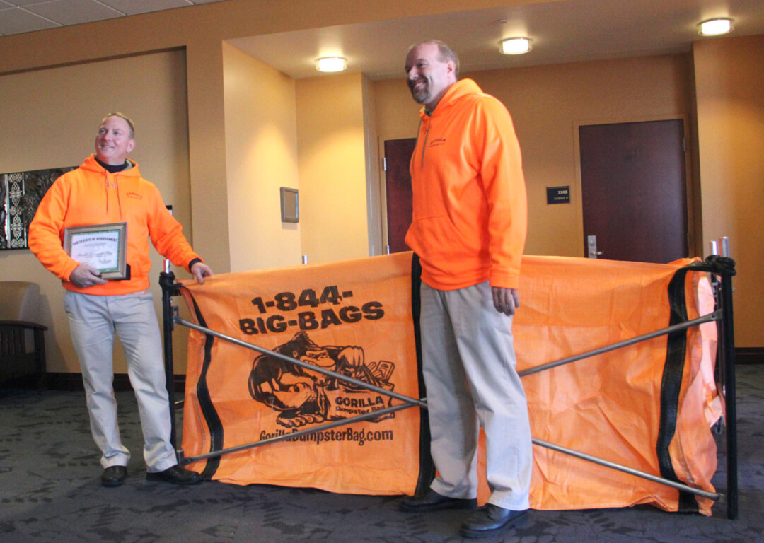 IN THE BAG. Steve Faacks and Chris Hansen show off an example of their Gorilla Dumpster Bag after being announced as winners of the 2015 Idea Challenge Dec. 3 at UW-Eau Claire.