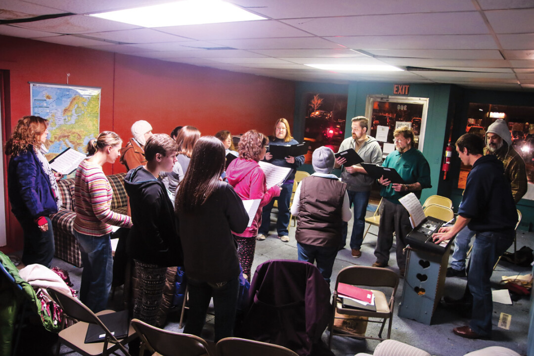 SINGIN’ TOGETHER. Michael Rambo leads a crew of community singers as the CollECtive Choir rehearses together for an upcoming show at The Plus on Dec. 13.