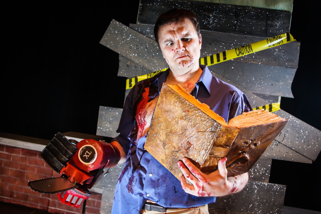 A LITTLE NIGHT READING. Jason Lyn stars as Ash, the chainsaw-wielding hero of the Eau Claire Children’s Theatre production of Evil Dead: The Musical.