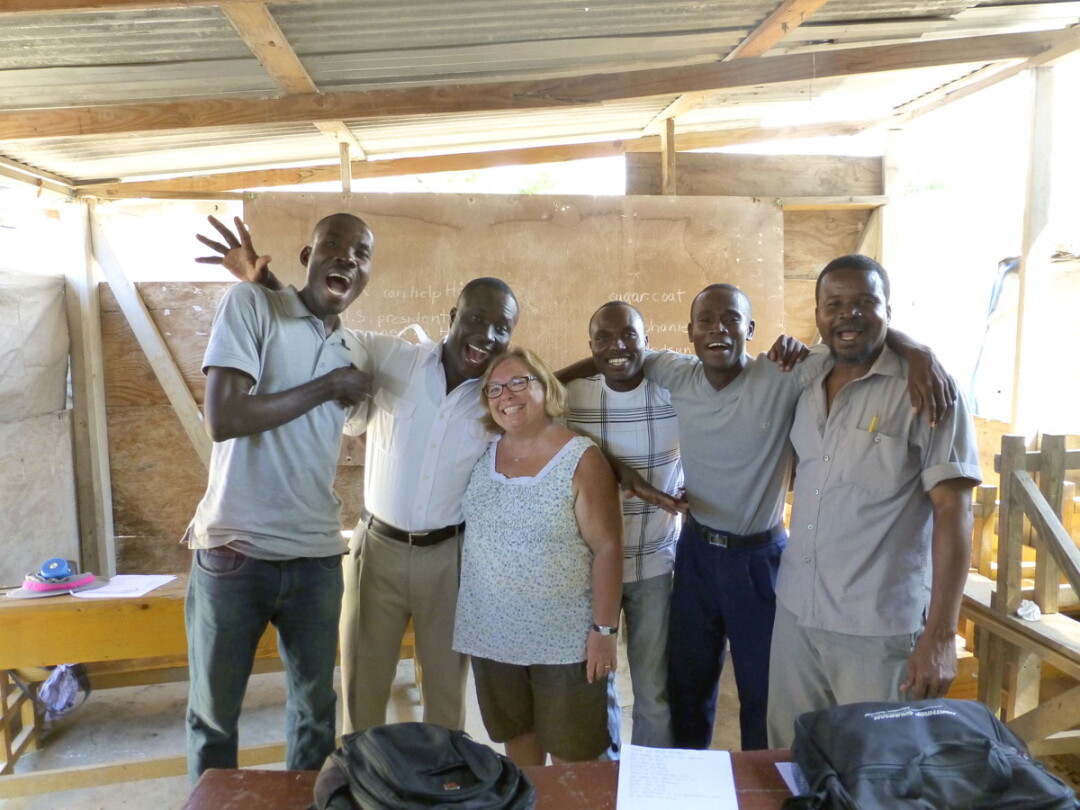 ALL SMILES. Bonni Knight, center, with teachers at the English in Mind Institute in Port-au-Prince, Haiti. Knight is organizing fundraisers for the school at the end of the month.