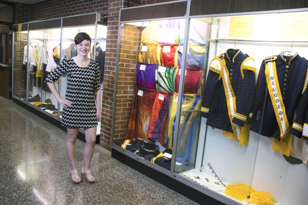 Brittaney McCarthy and the Blugold Marching Band uniform display