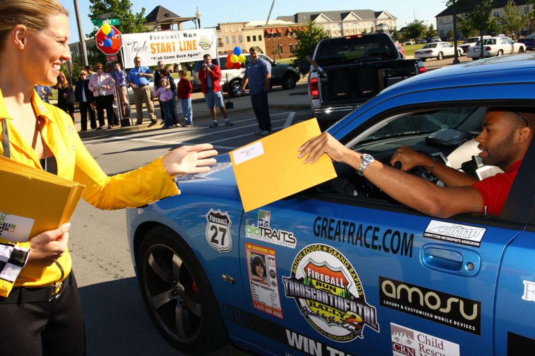 THE ENVELOPE, PLEASE. A competitor in a past season of Fireball Run gets his instructions for one leg of the road rally TV series. The show, which airs on Amazon Prime, will film in Eau Claire next fall.