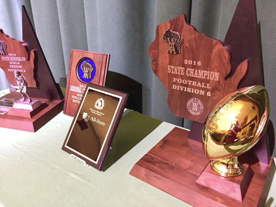 Recent trophies and awards won by Regis High School, including the WIAA Division 6 football trophy at right. Image: Regis Catholic Schools