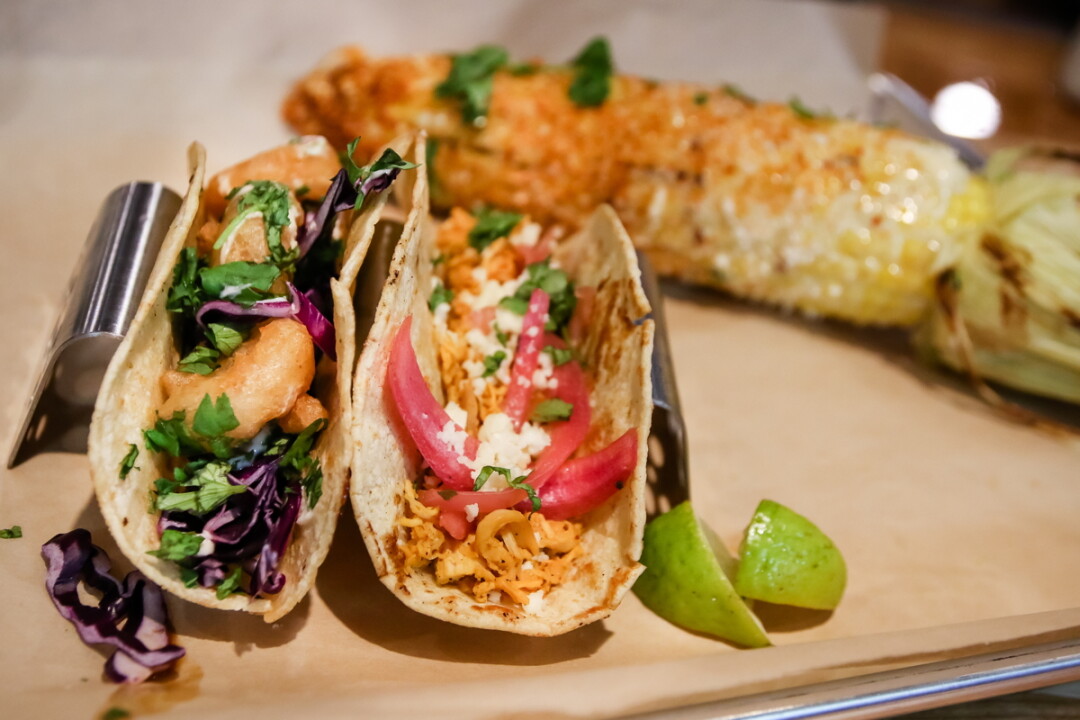 NOT JUST FOR TUESDAYS ANYMORE. Roble Tacos + Tequila features wood-fired dishes such as Baja Shrimp and Wood Roasted Chicken tacos (above)  and Mexican street corn (below, center). The drink menu includes margaritas (below left, from left to right) such as the Roble House Margarita, Desert Pear, Roble’s Best, and Roble Signature Jalapeno Strawberry. The restaurant is located at 5020 Keystone Crossing, Eau Claire.