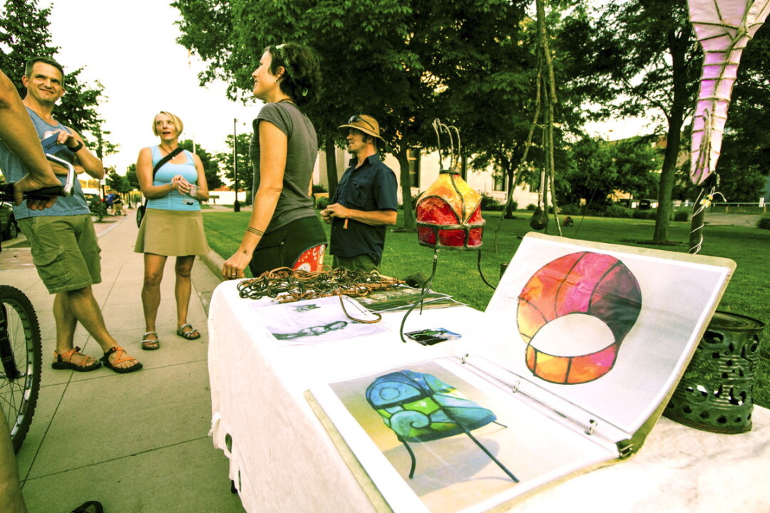 STREET ART. Brianna Capra and Brent Gonyea, center, were among the artists who displayed works in downtown Eau Claire during the Prex Claire festivities.