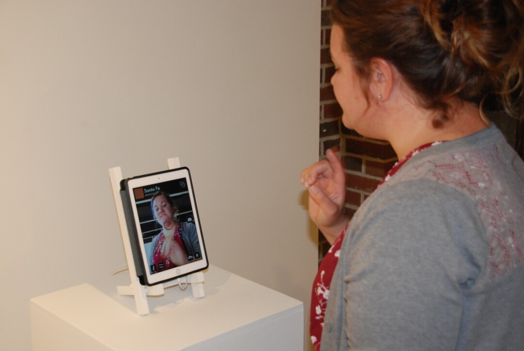 Amanda Bulger, interim director of the Foster Gallery, is shown via an app that identifies specific colors in an image.