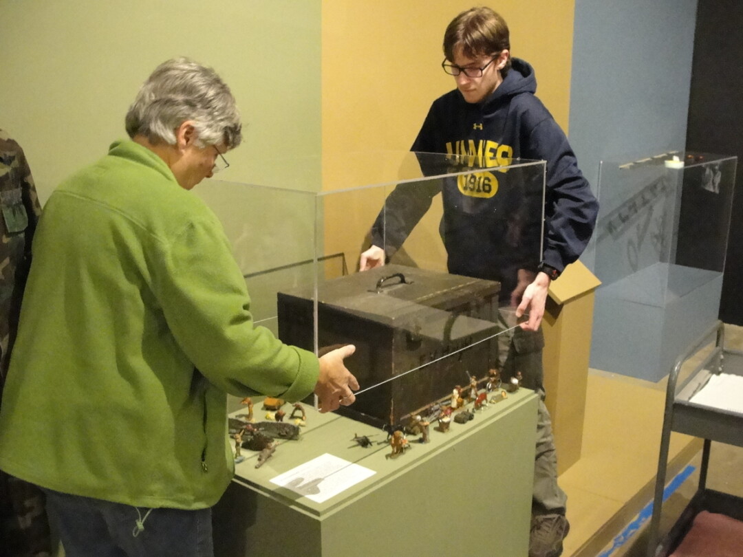 A COLLABORATIVE CASE. Students designed and assembled the displays for 23 artifacts, including this set of military figurines, to prepare for the Making Meaning exhibit.