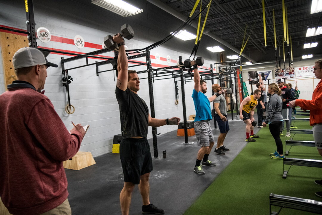 EVERY DAY IS ARMS DAY. Members of Momentum Fitness in Eau Claire have been competiting in a Friday Night Lights event to raise money for kids at DeLong Middle School.