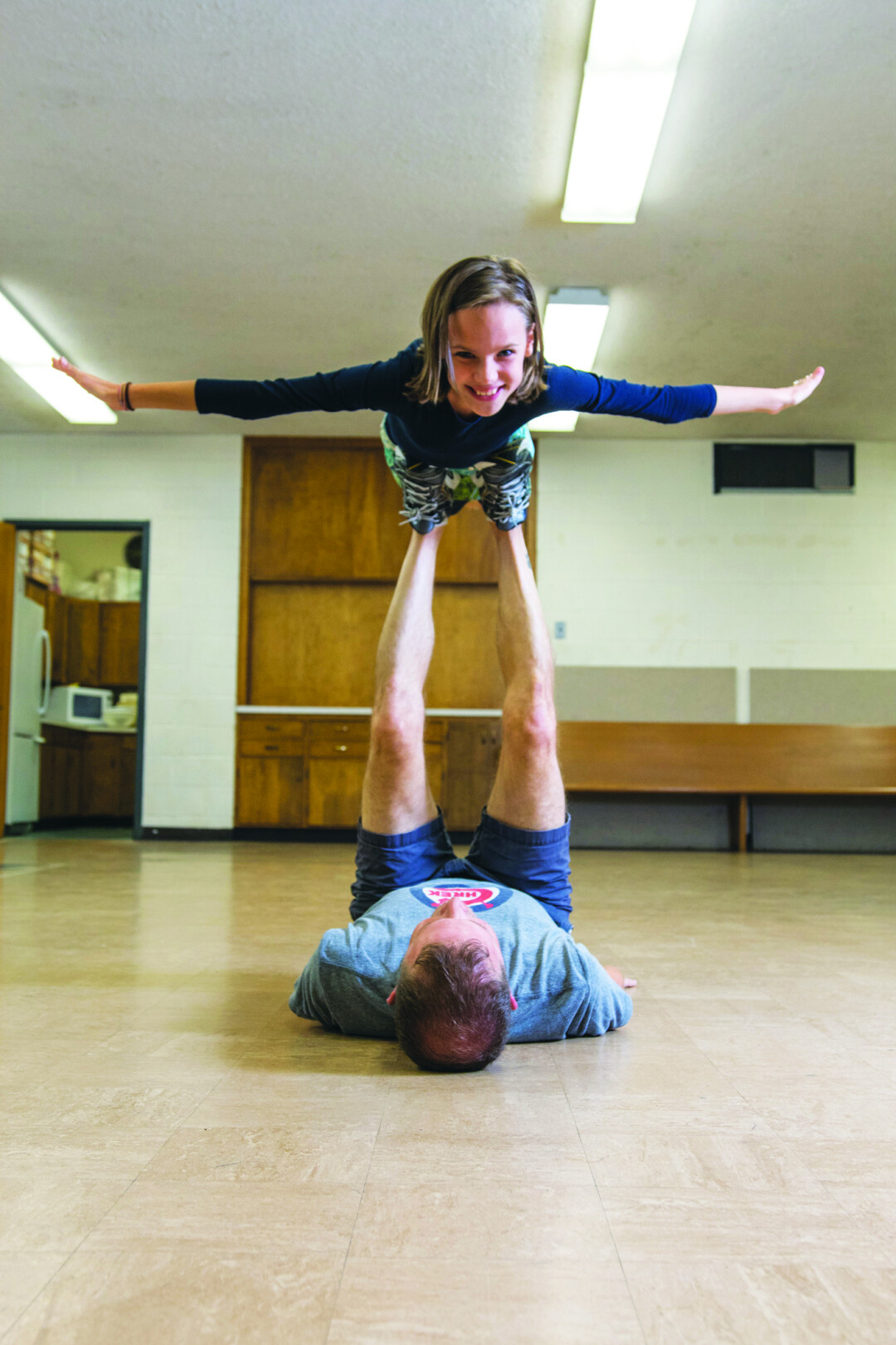 IT ALL COMES BACK. Joel Breed (Bruce Bechdel) and Charlotte Schaller (Small Alison) practice playing airplane for a touching scene in the Chippewa Valley Theatre Guild’s production of Fun Home.