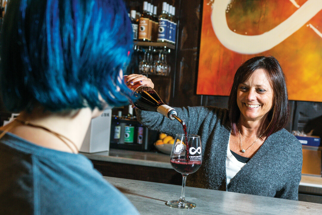 Melissa Christianson, front of house manager, pours a complimentary taste for a visitor at the Tasting Lounge.