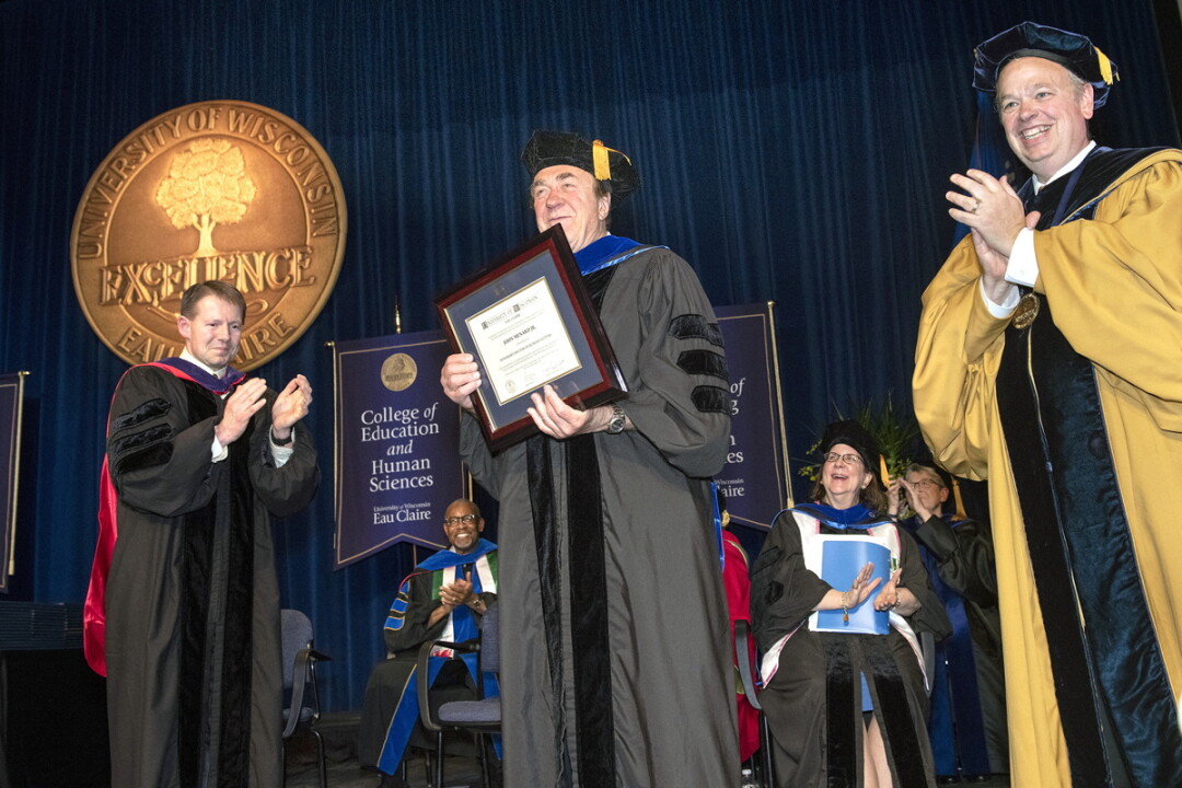 John Menard, center, collects an  honorary doctorate from UW-Eau Claire