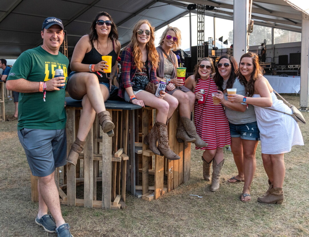 MAKING FRIENDS IN THE COUNTRY. Each summer, Country Jam draws thousands of fans to Eau Claire to enjoy their favorite musicians – and each other’s company.