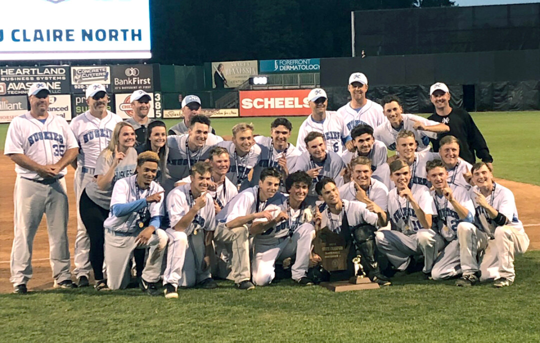 The Huskies pose with their championship trophy on June 13
